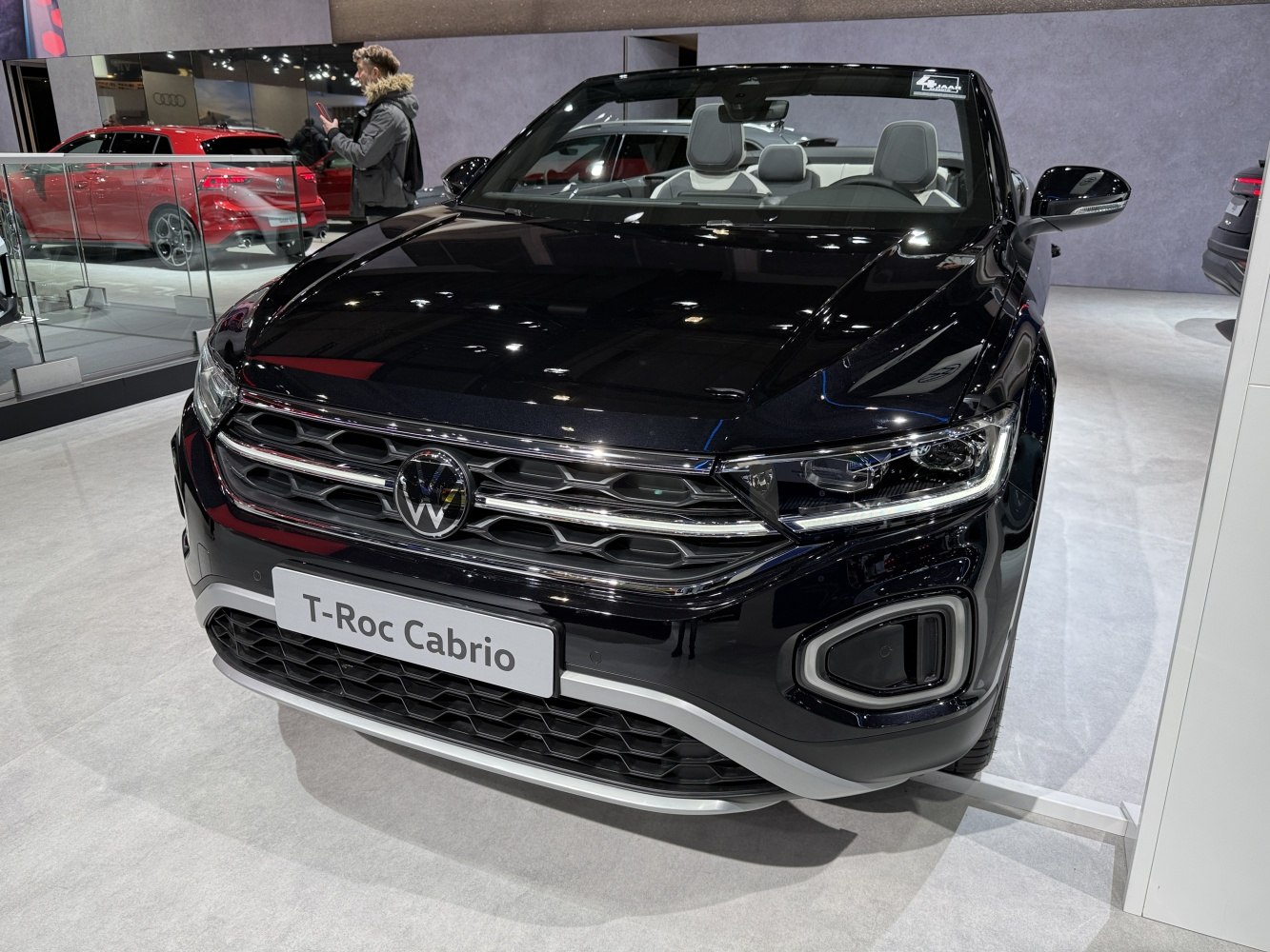 Front view of a modern convertible with LED headlights and honeycomb grille