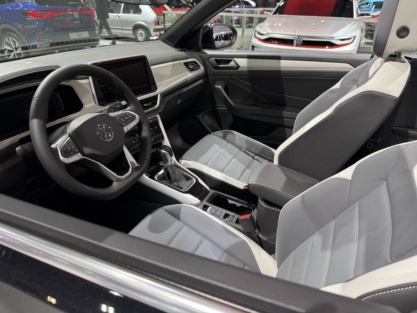 Modern steering wheel and dual-tone front seats in car interior