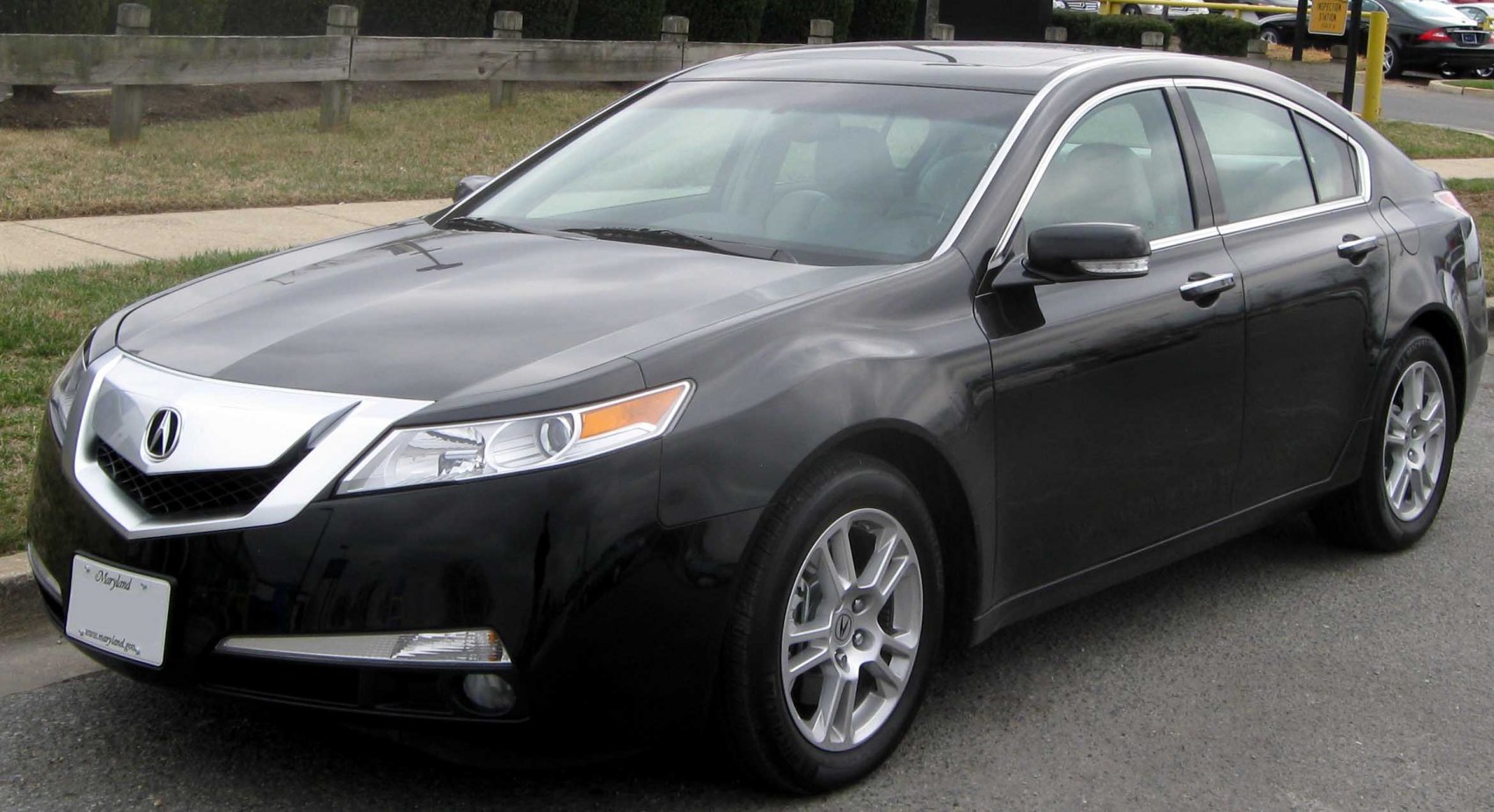 Sleek sedan front view with alloy wheels