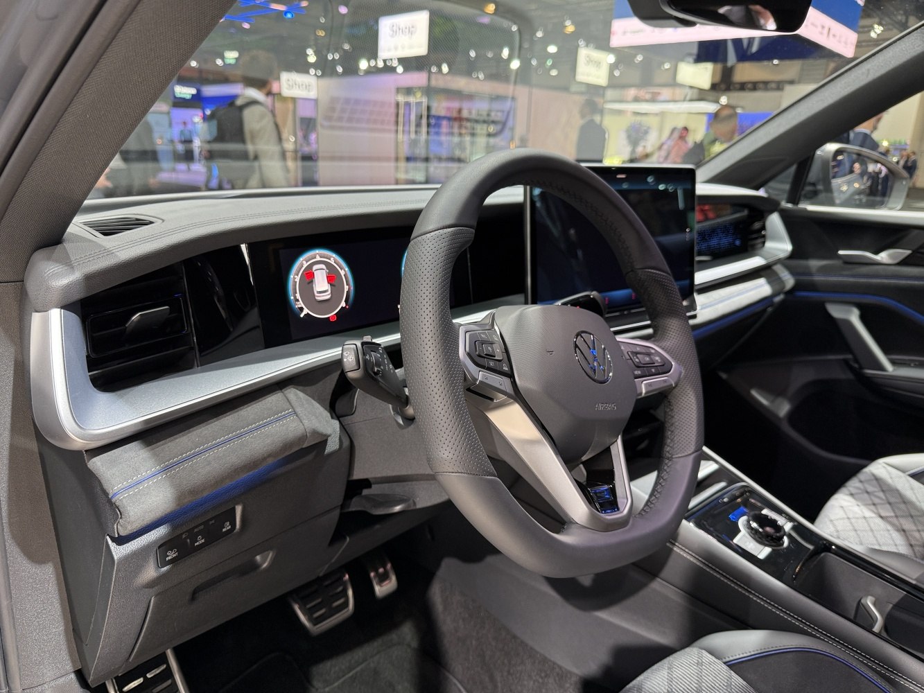 Modern digital dashboard and multifunction steering wheel in car interior