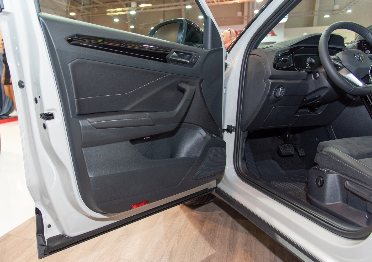 Car door interior panel with armrest and driver’s footwell with pedals