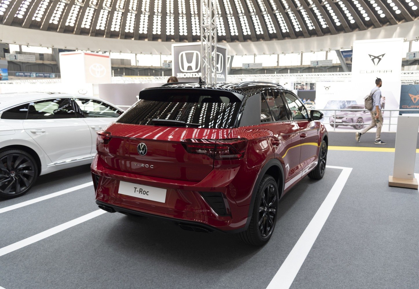 Rear view of dark red SUV with black roof and sleek tail lights