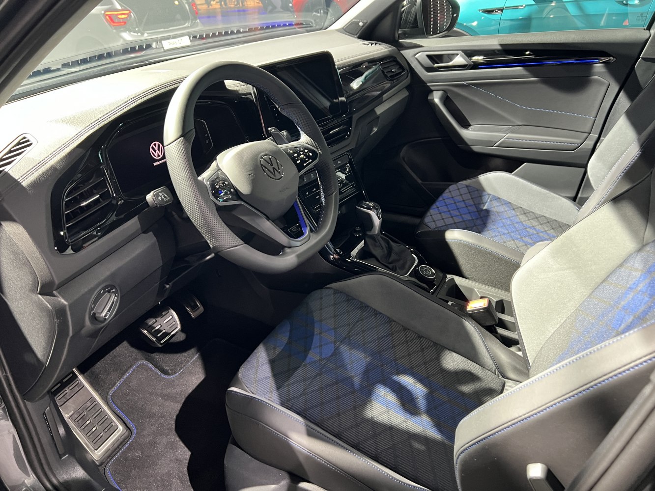 Modern car interior with digital dashboard and patterned seats