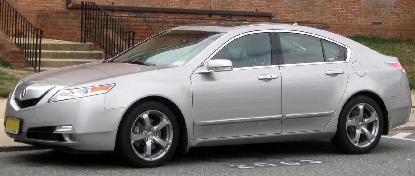 Silver four-door sedan side profile with alloy wheels