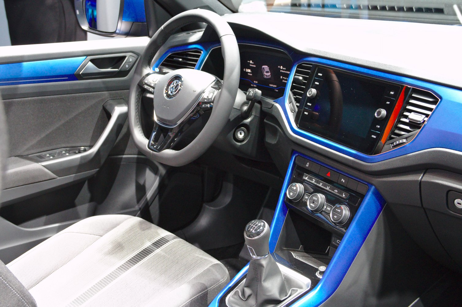 Manual transmission with digital dashboard and blue-accented interior
