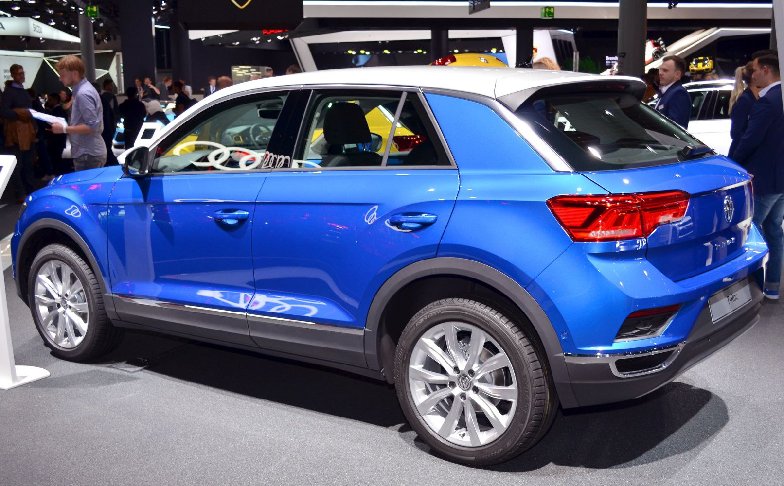 Blue compact SUV side and rear with white roof and alloy wheels