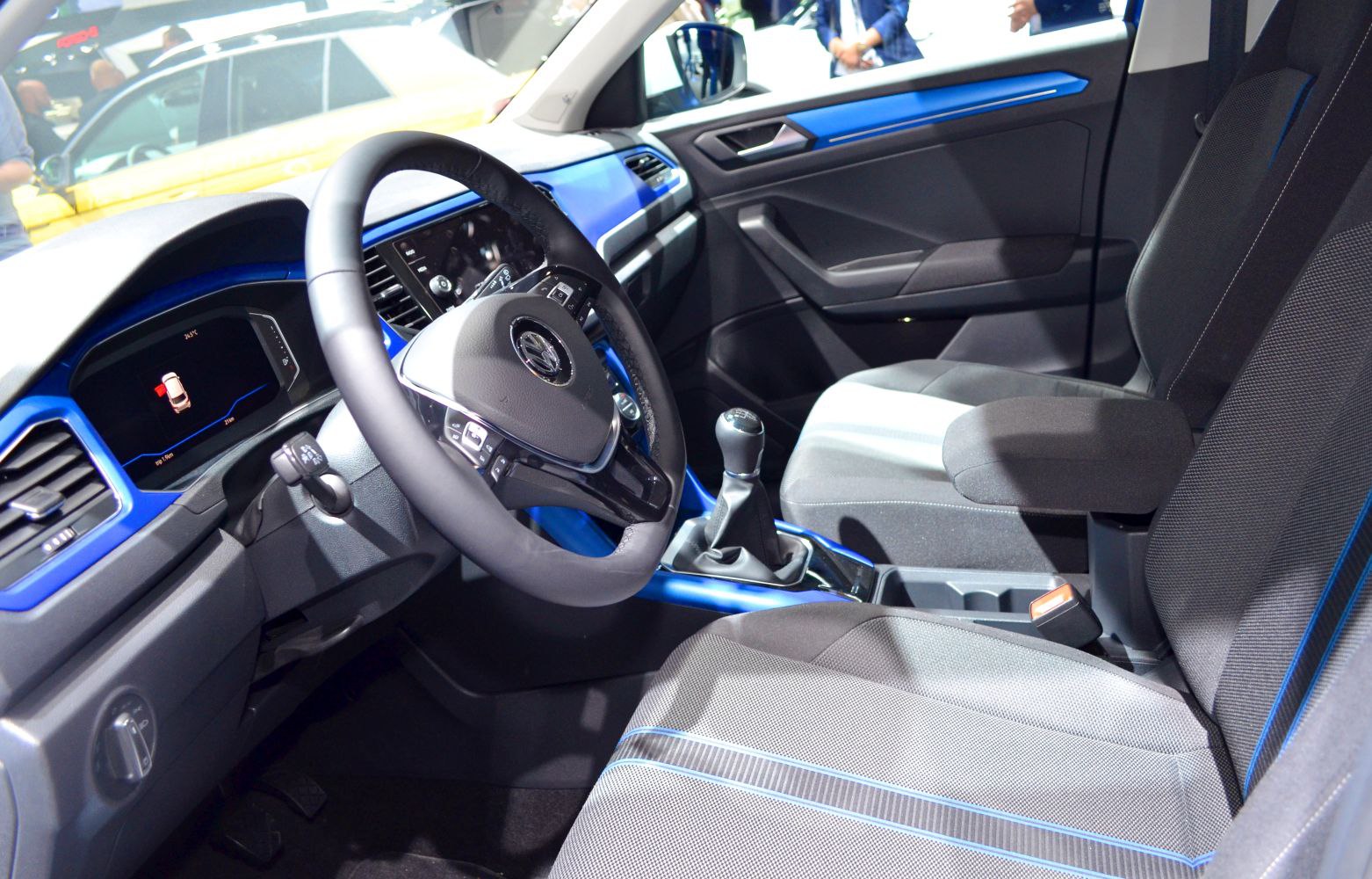 Dashboard and steering wheel with blue trim and seats in car interior