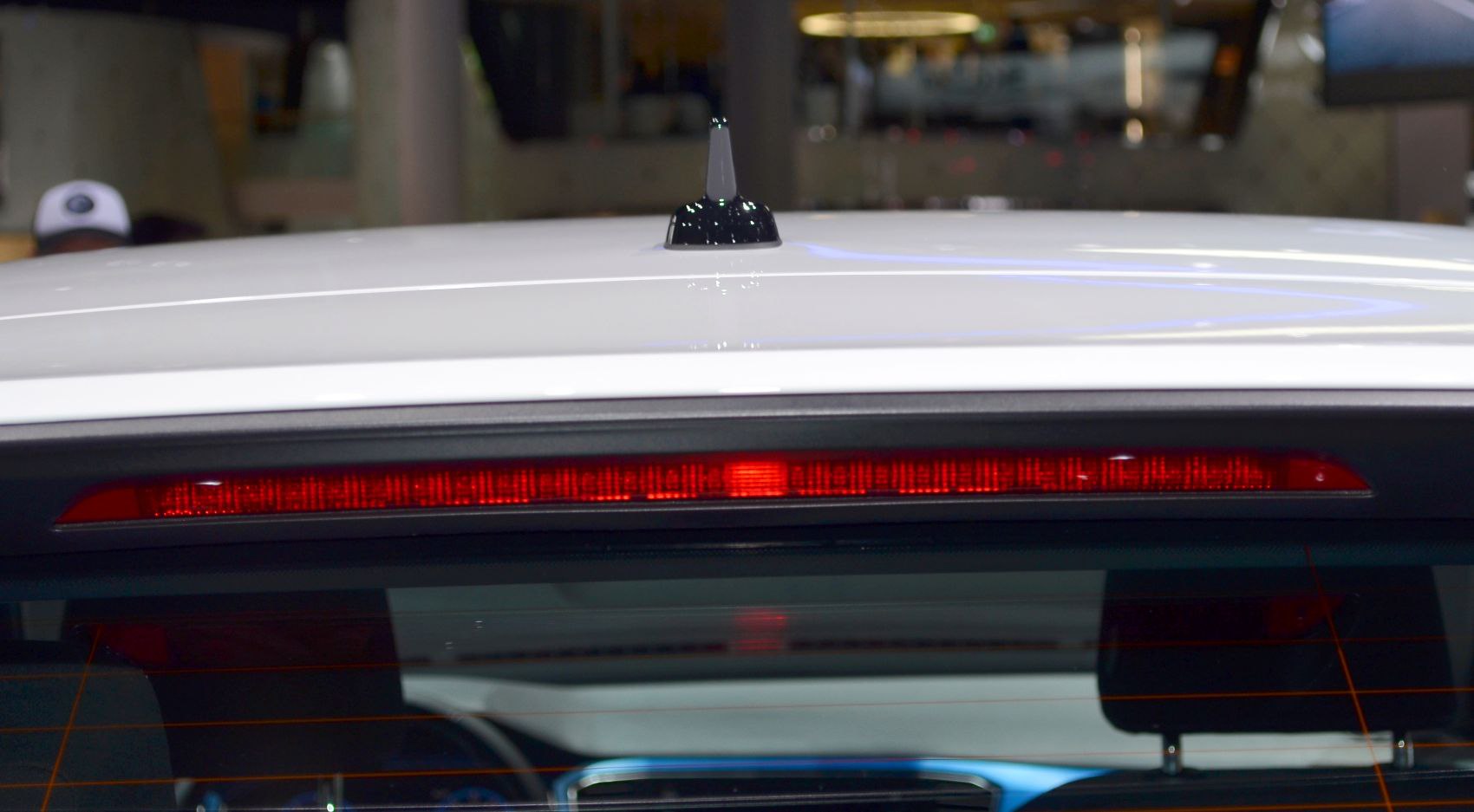 Rear roof brake light and shark fin antenna on a vehicle
