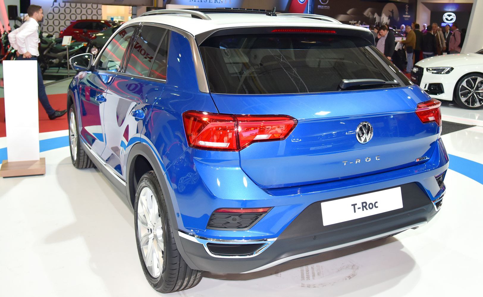 Rear view of blue SUV with distinct taillights and silver roof rails