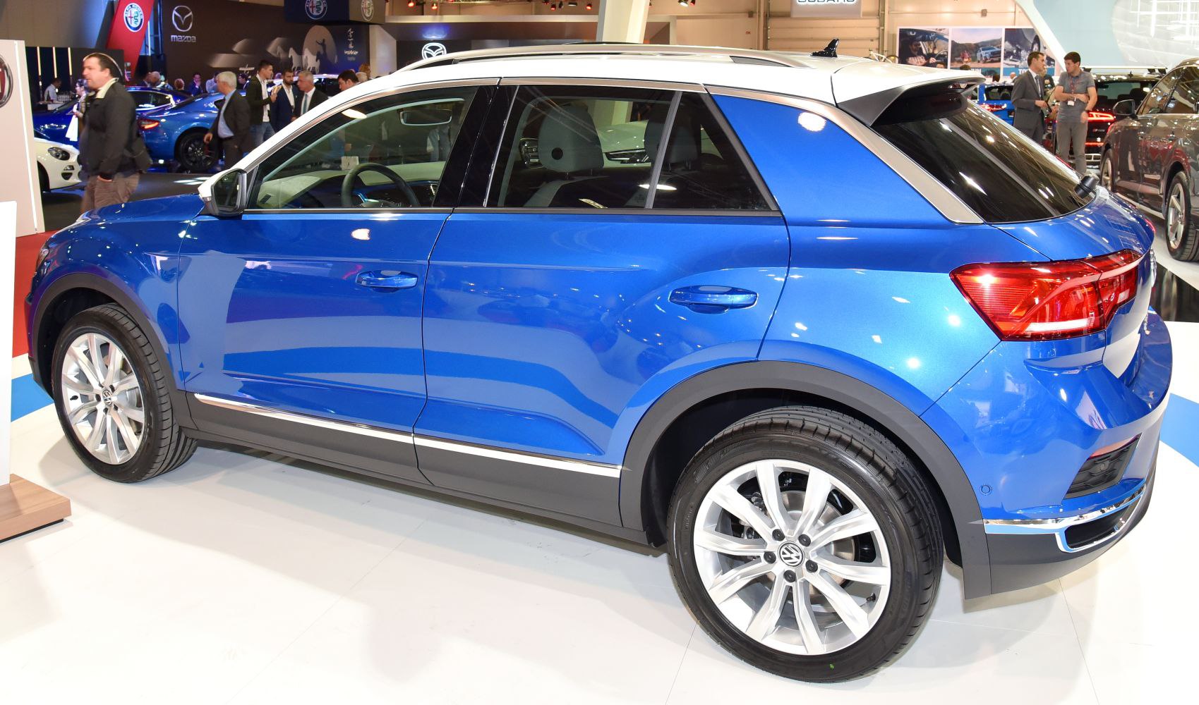 Blue compact SUV side view with white roof and alloy wheels