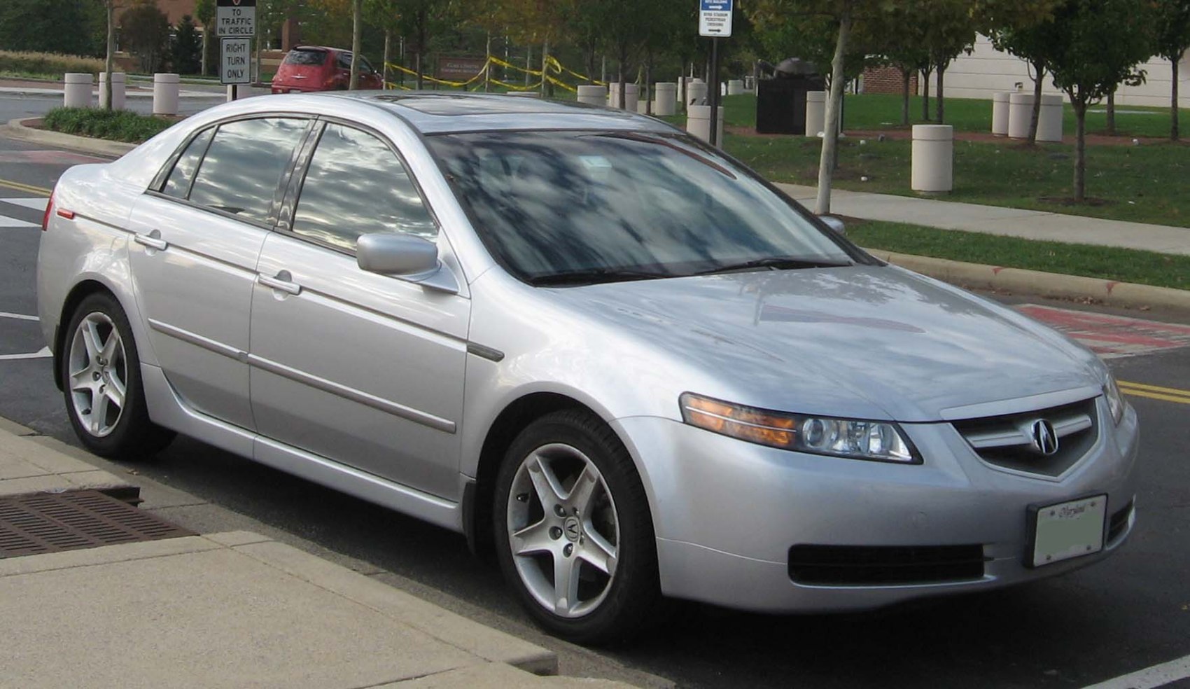 Silver sedan with projector headlights and five-spoke alloy wheels