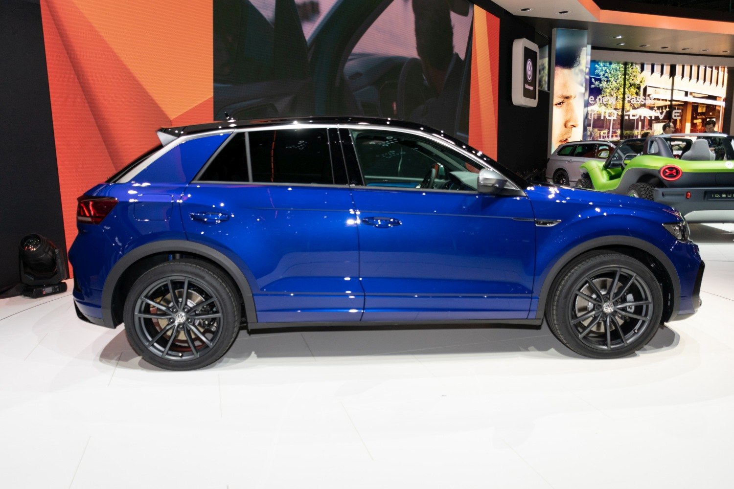 Blue SUV with black alloy wheels in side profile