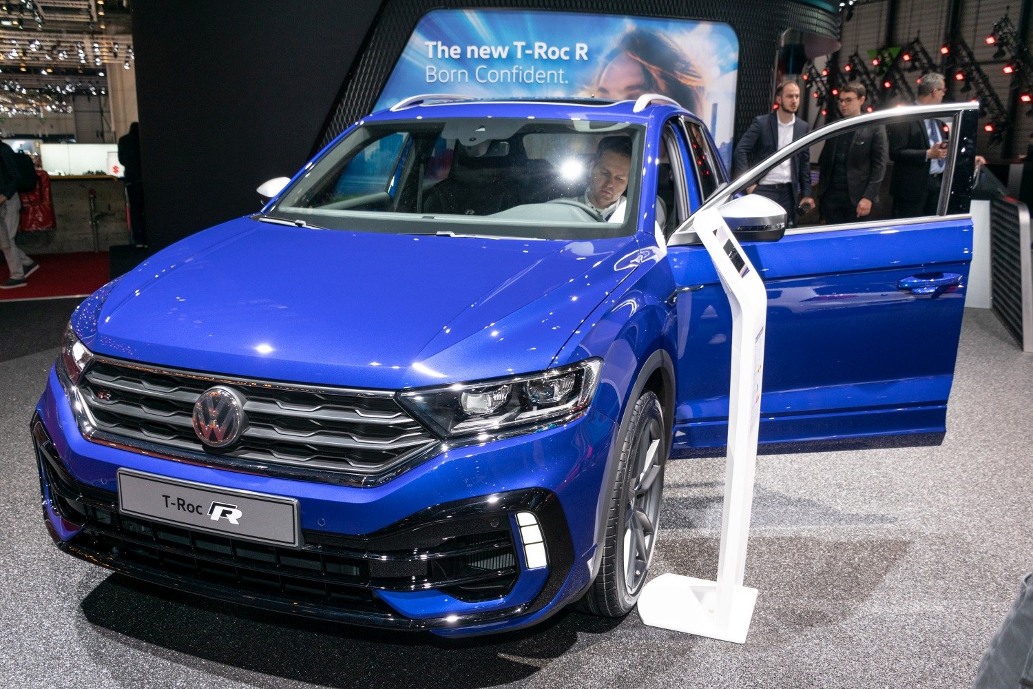 Front view of blue car with LED headlights and open door
