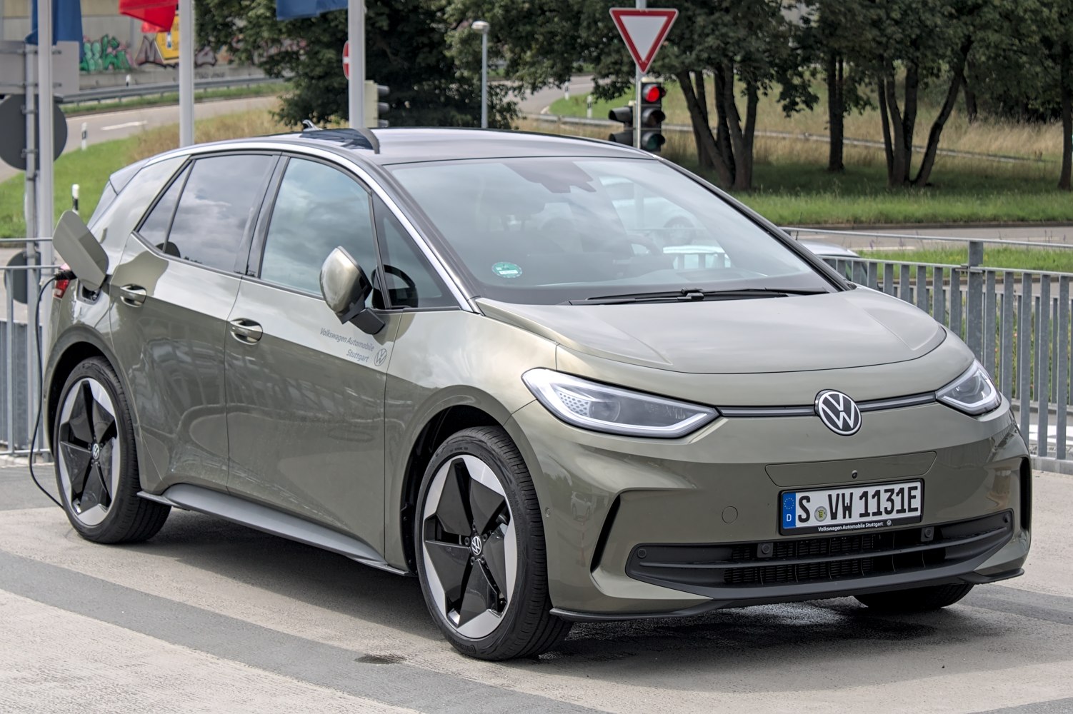 Front three-quarter view of electric hatchback with aerodynamic wheels and sleek headlights