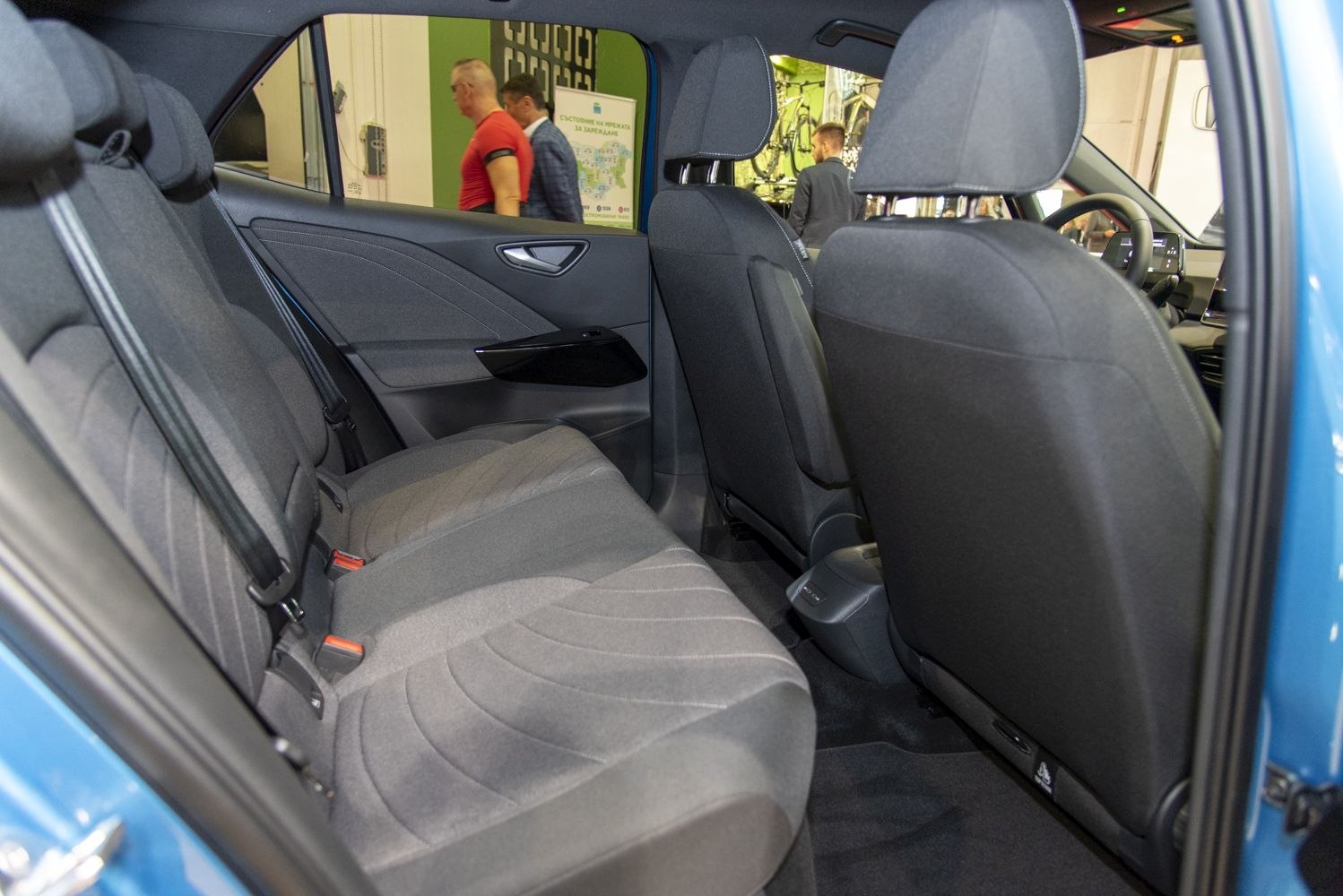 Rear passenger seats and door panel with grey fabric upholstery