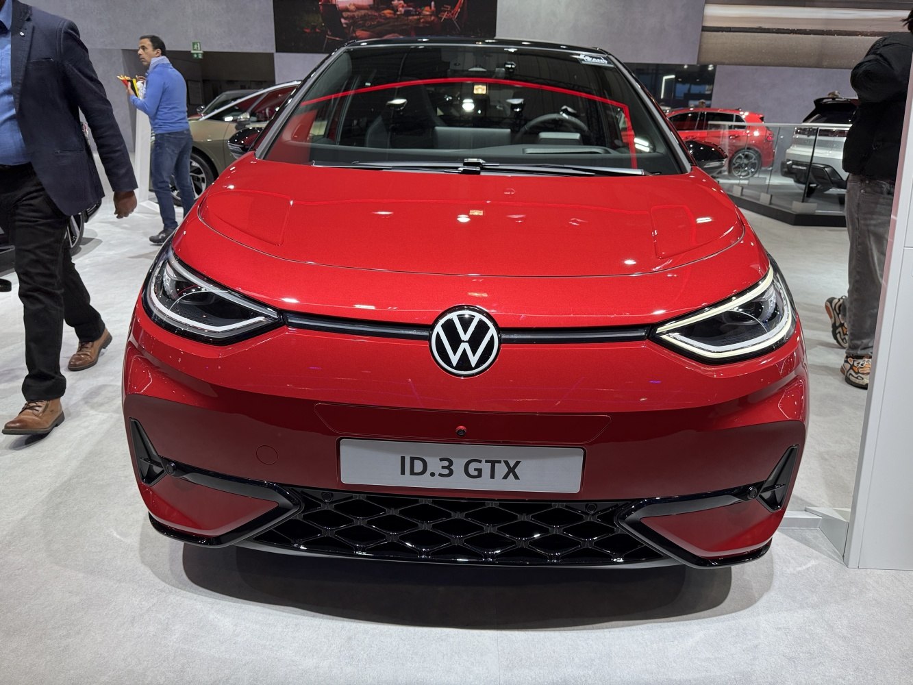 Red car front with LED headlights and distinctive grille