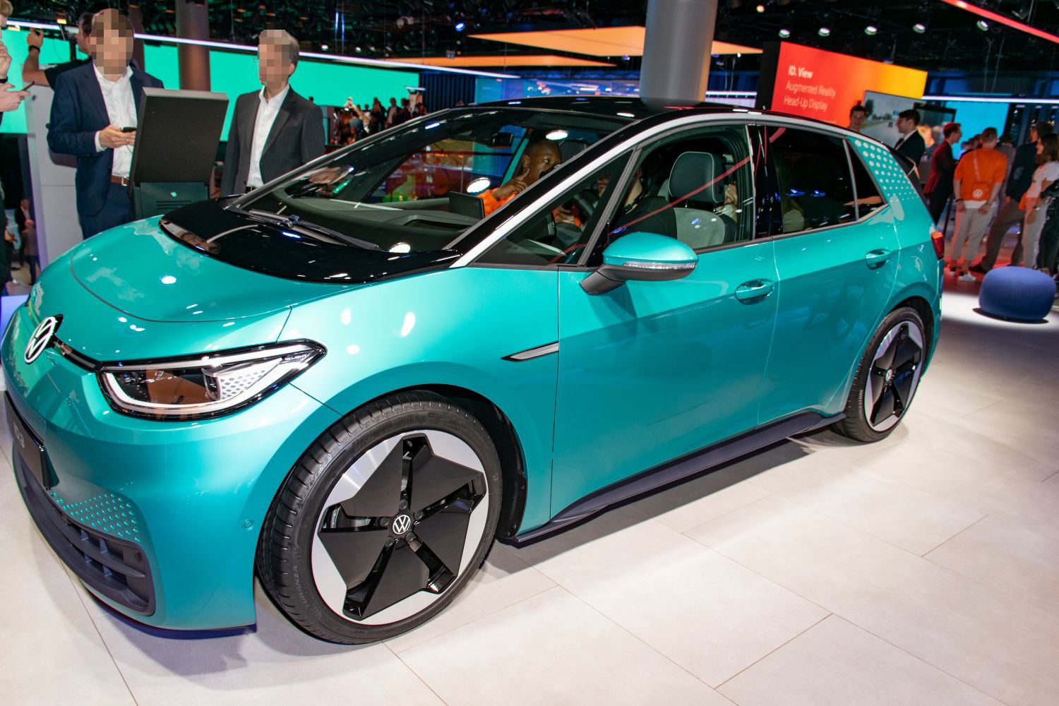 Front-side view of a futuristic electric hatchback with aerodynamic shape and distinct wheels