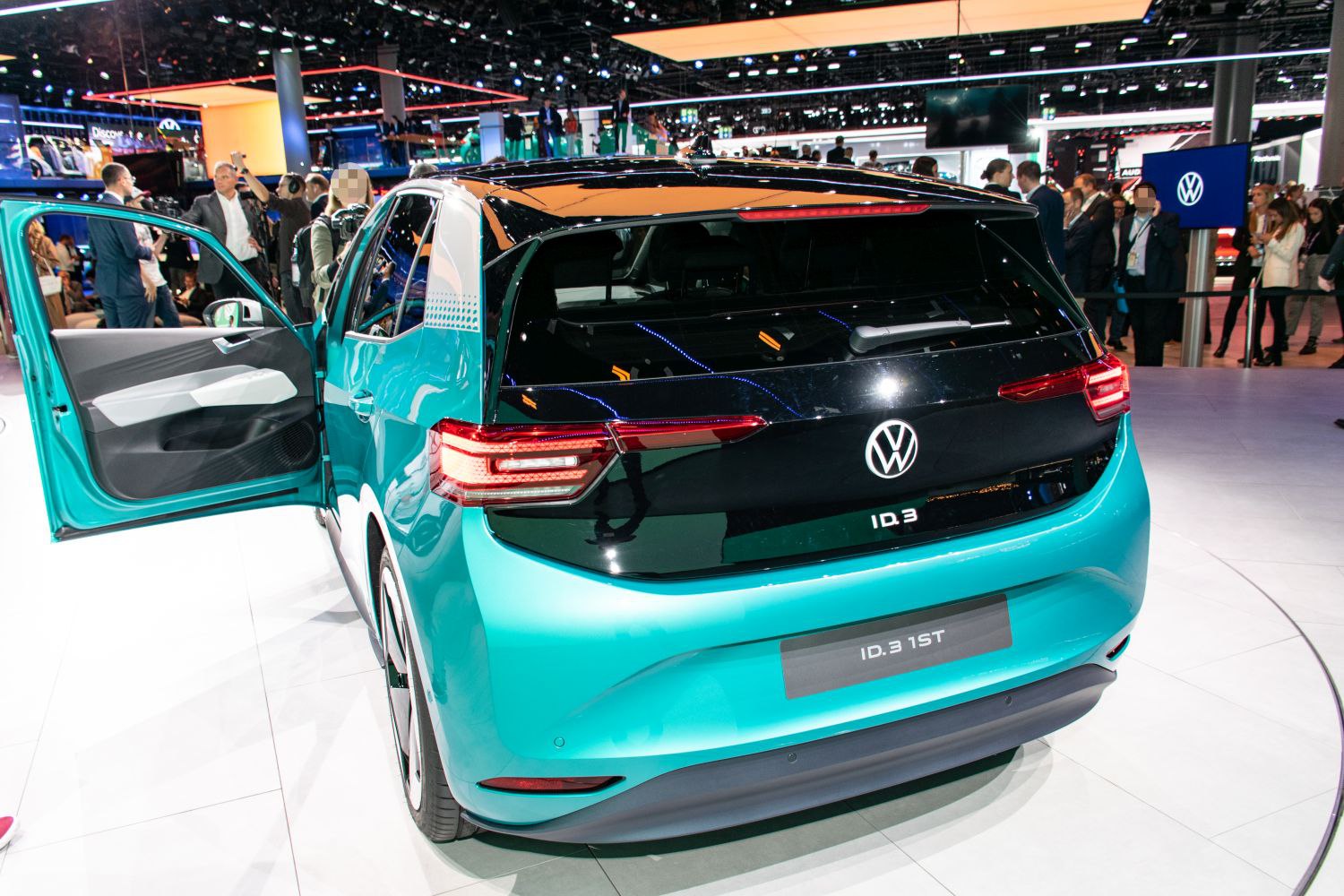 Rear view of electric hatchback with sleek taillights and open door