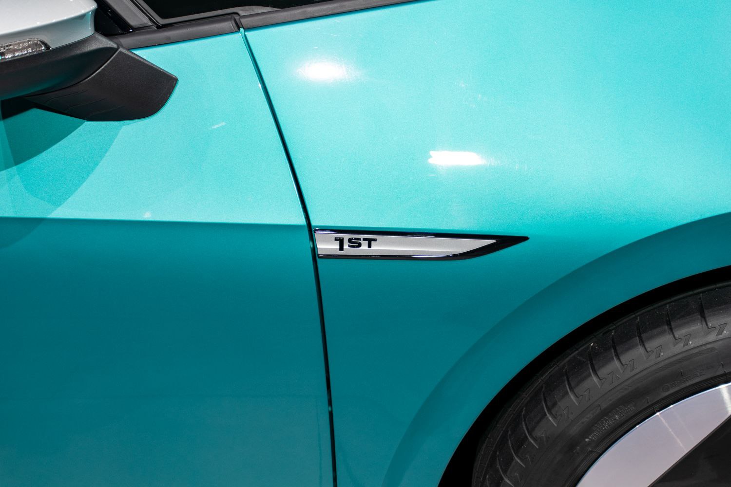 Close-up of electric vehicle side badge and front wheel detail