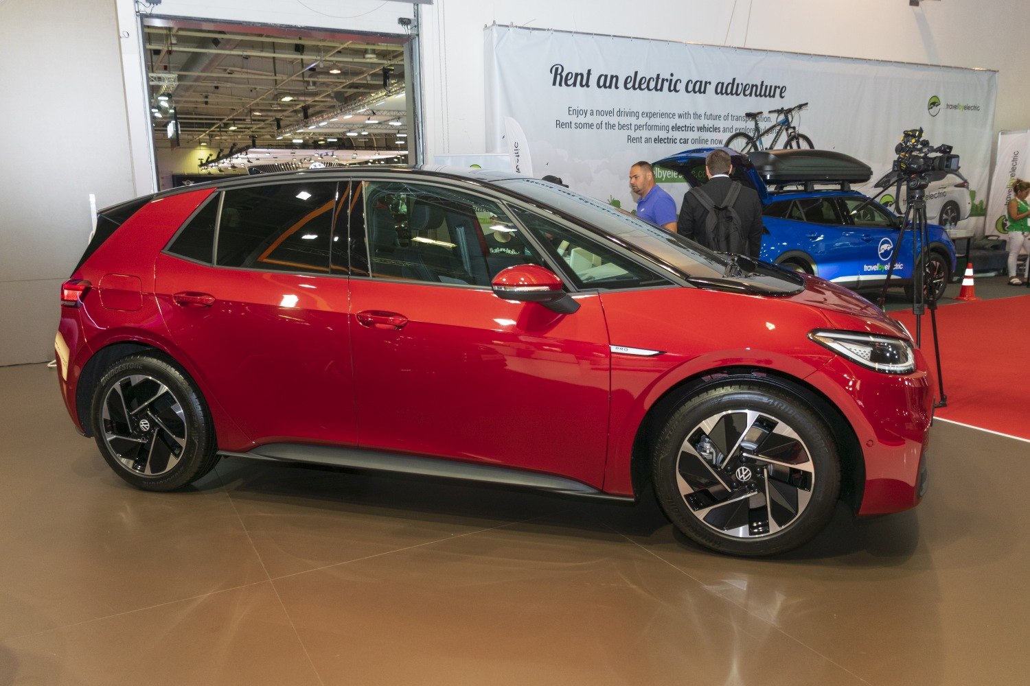 Red electric hatchback side view with LED headlights and alloy wheels