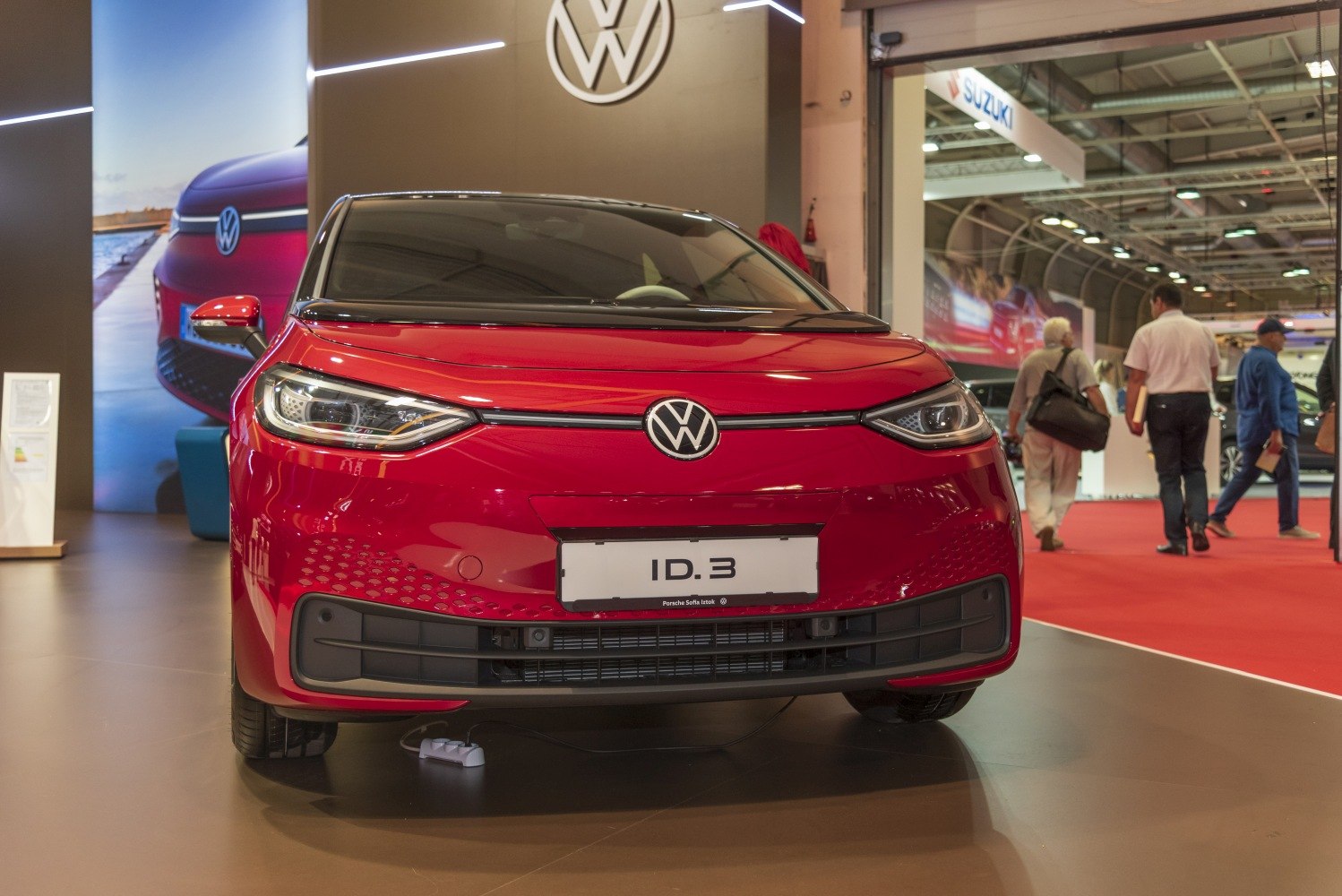 Front view of a red electric vehicle with sleek LED headlights and Volkswagen emblem
