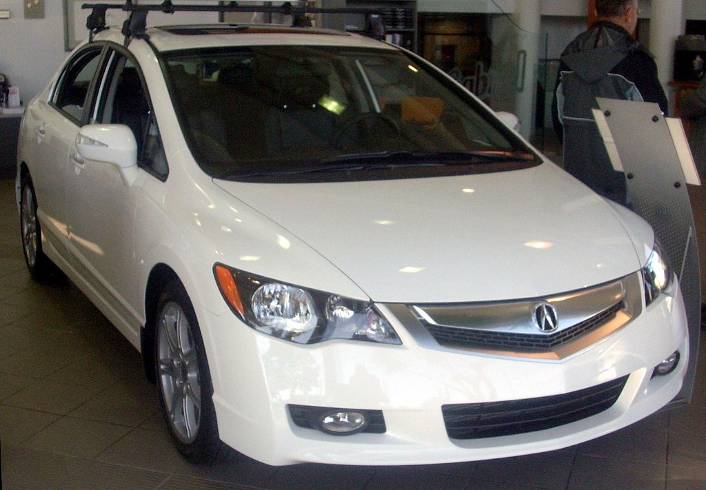 Front and side view of facelifted sedan with distinctive grille and headlights