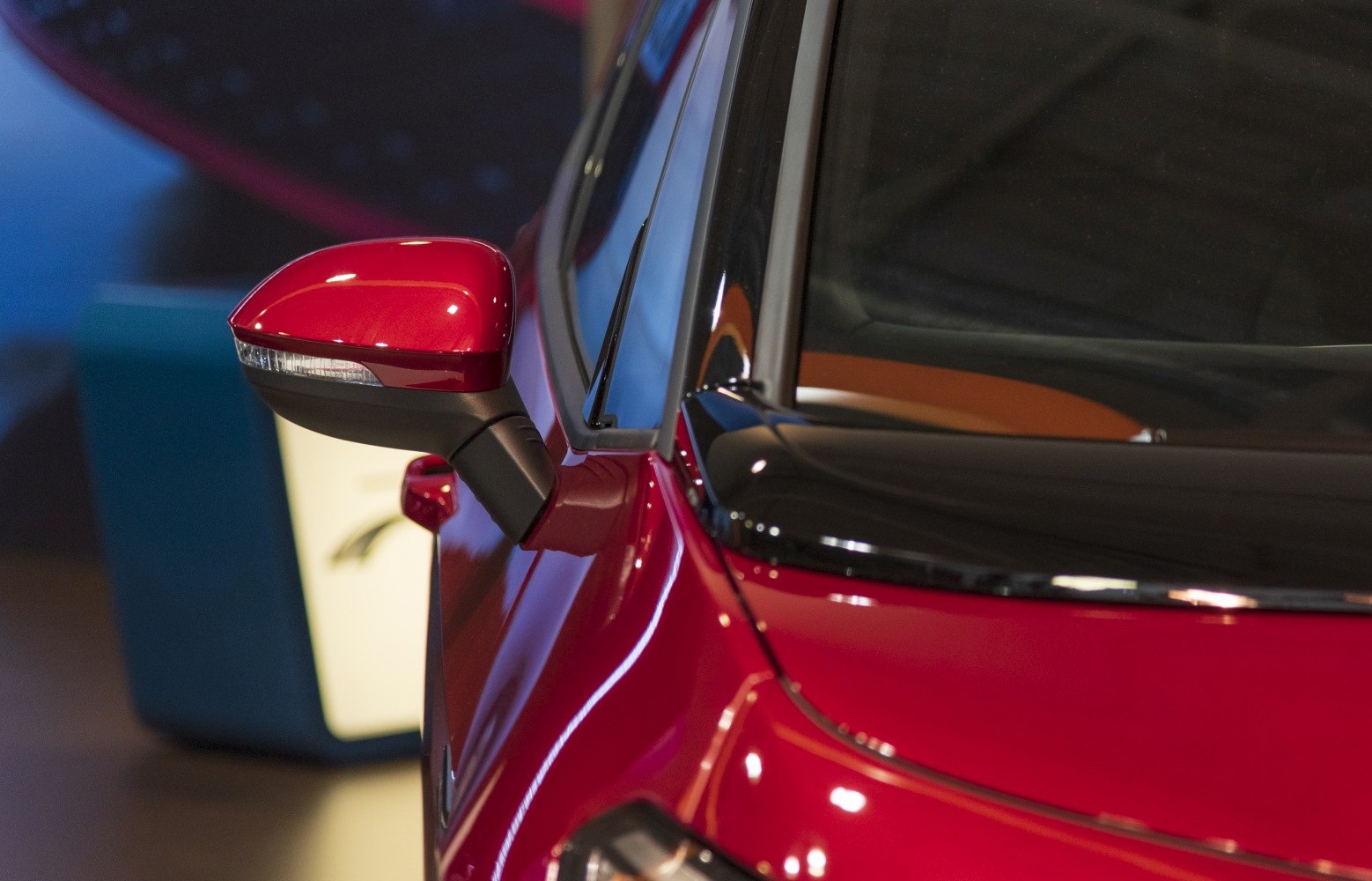 Red side mirror and windshield trim close-up