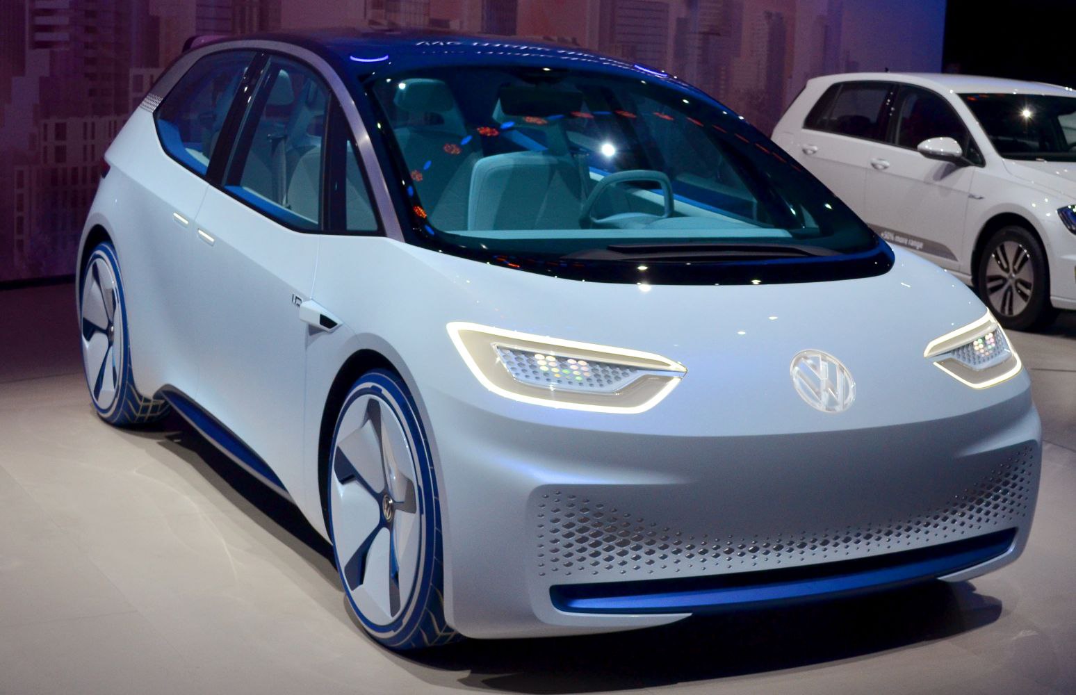 Futuristic aerodynamic electric hatchback with illuminated headlights