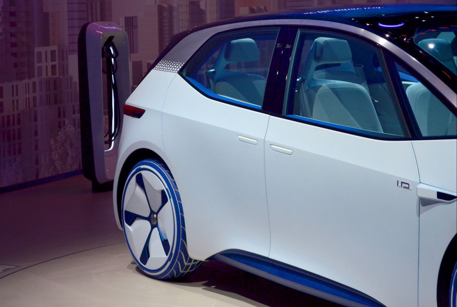 Sleek aerodynamic EV hatchback with futuristic wheel design and distinctive door handles