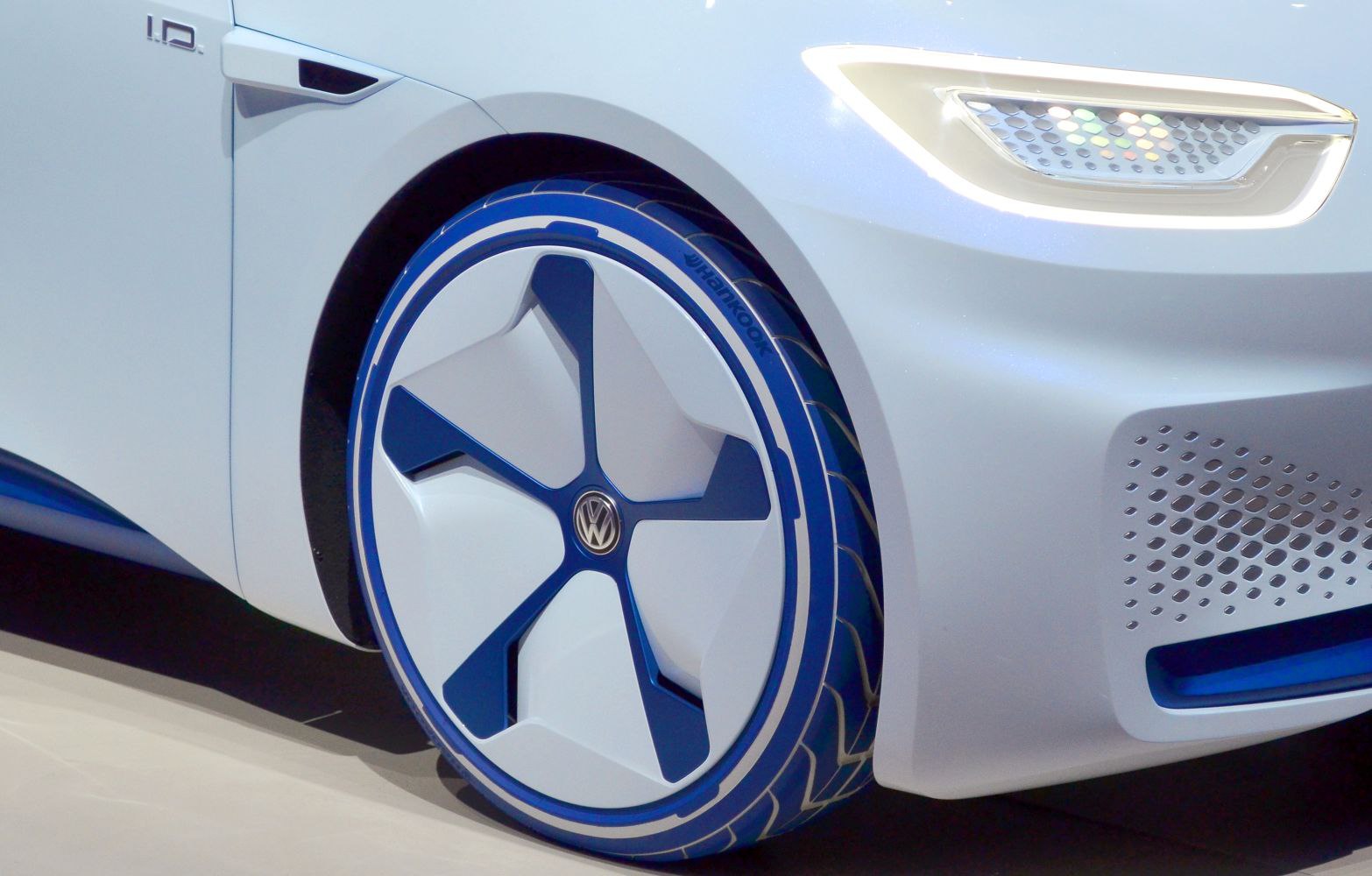 Futuristic wheel and sleek headlight design with blue accents