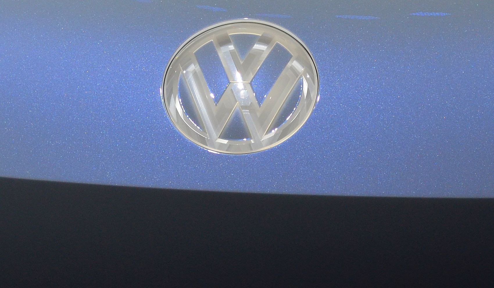 Close-up of Volkswagen emblem on blue metallic surface