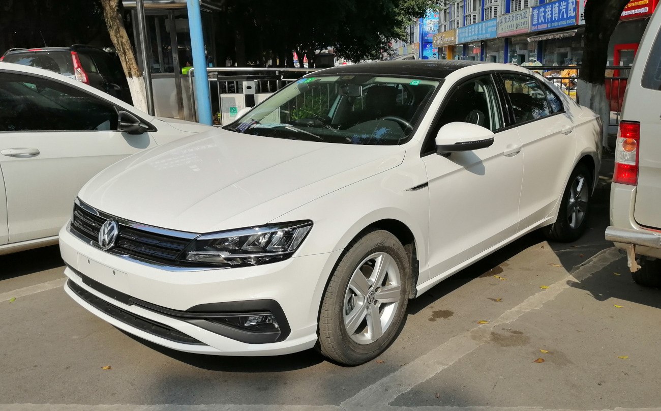 White sedan front-side view with alloy wheels