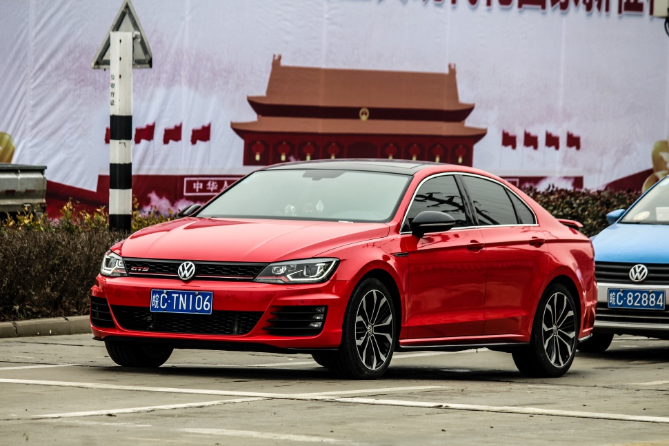 Red sports sedan with alloy wheels and modern headlights