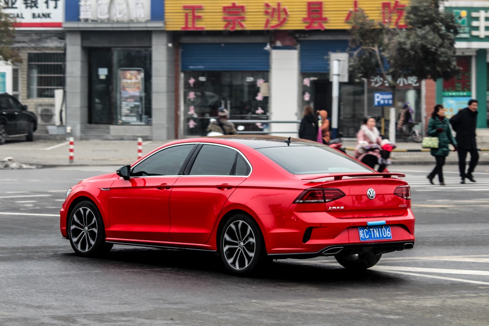 Red sporty sedan rear view with alloy wheels and tinted windows