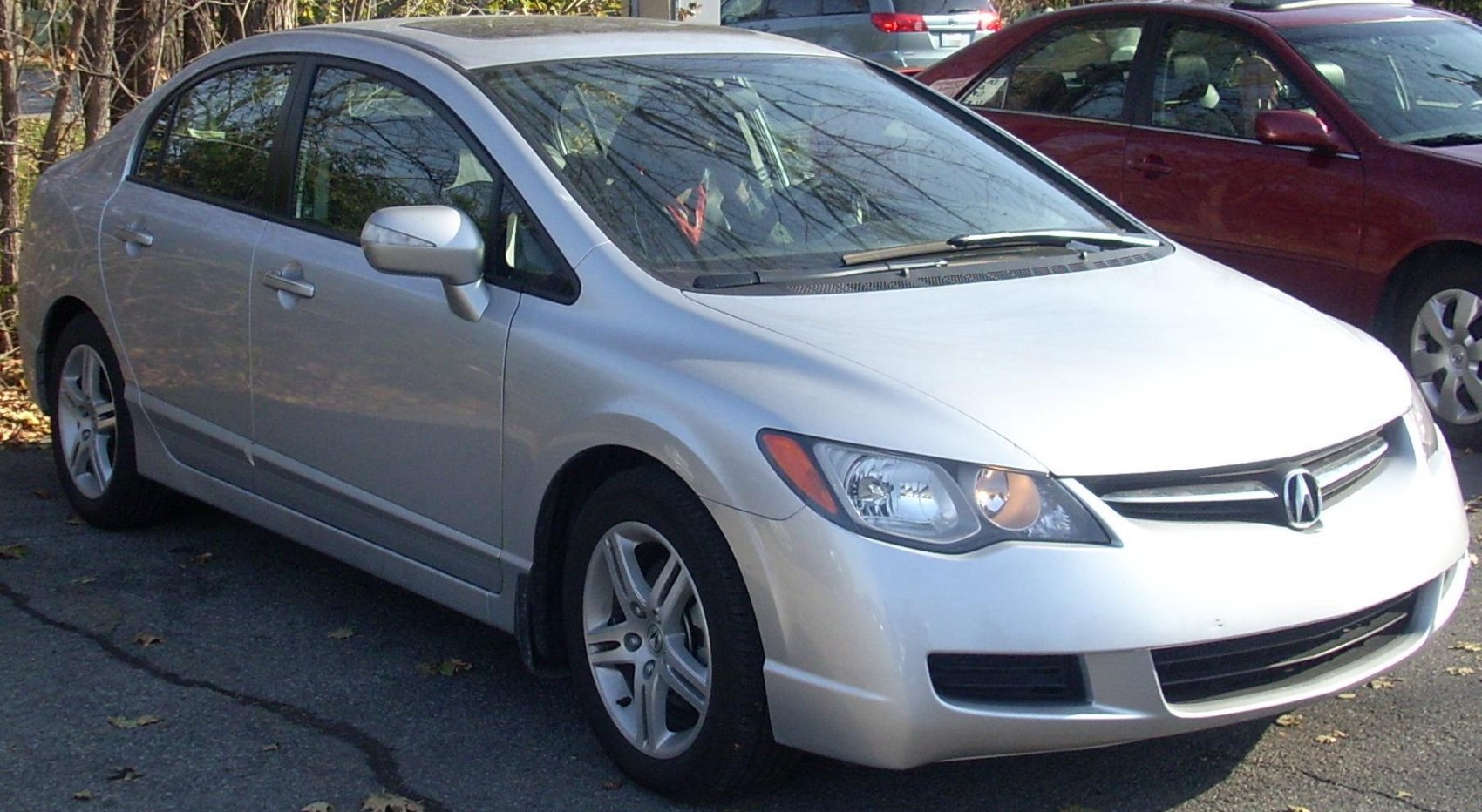 Silver sedan front side view with headlights and alloy wheels