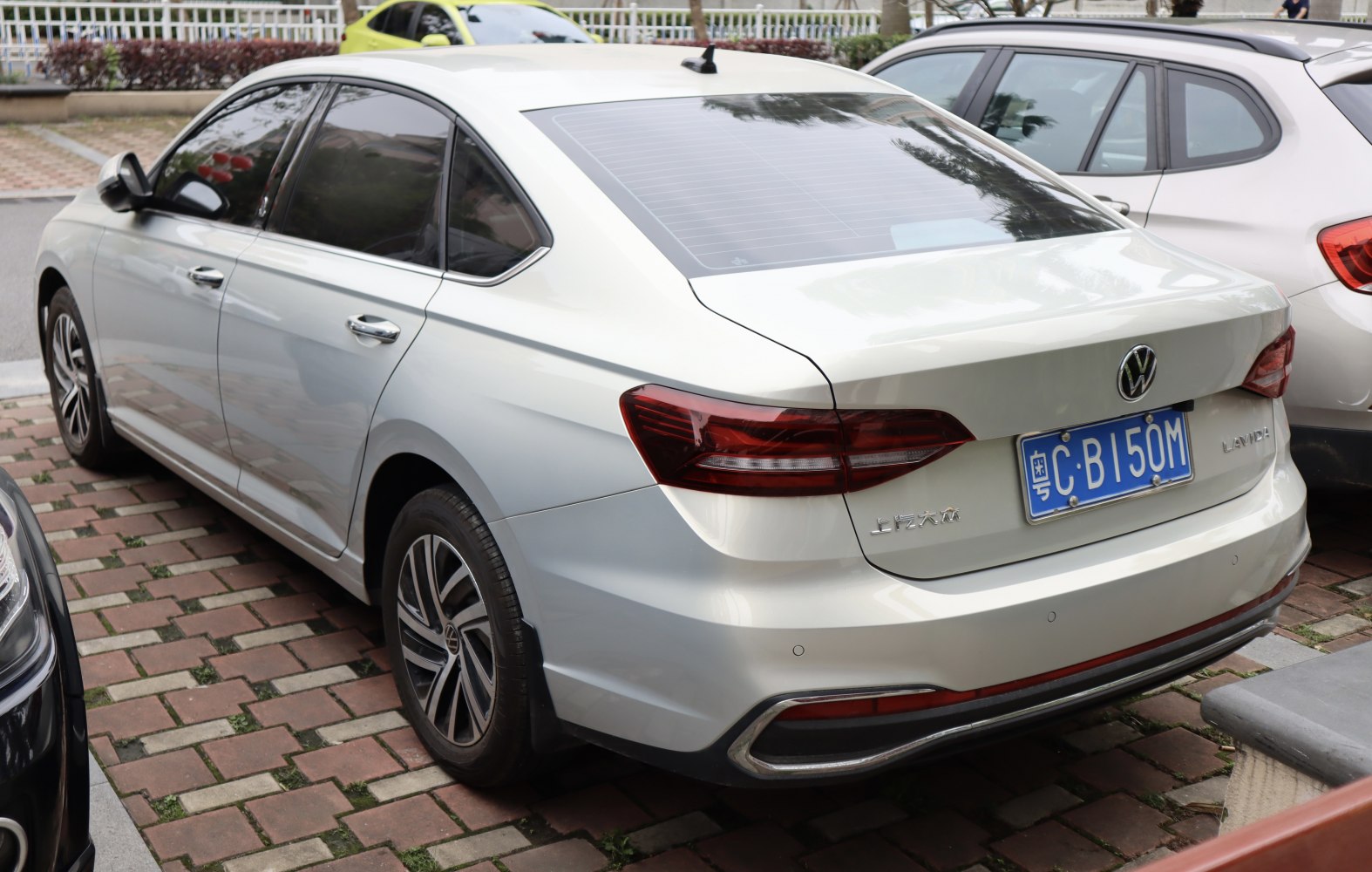 Rear view of a sedan with modern LED tail lights and chrome rear trim