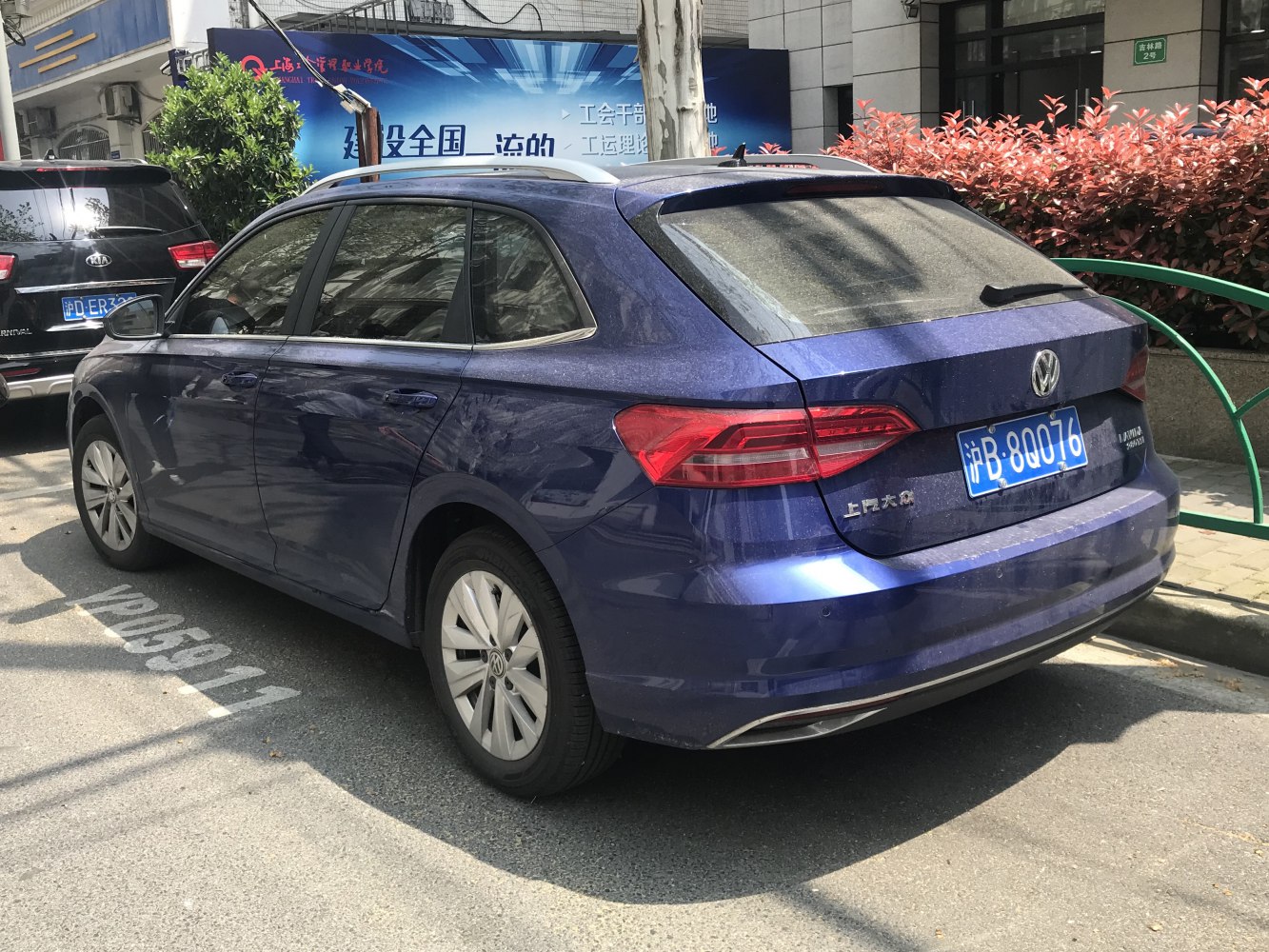 Blue station wagon rear side with integrated rear spoiler and modern taillights