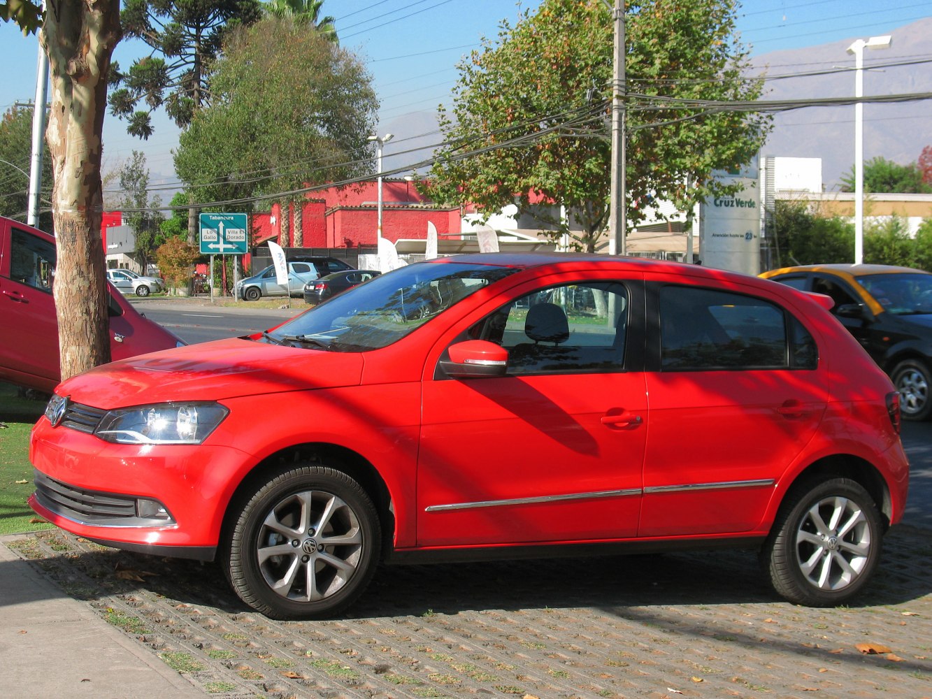 Red hatchback with alloy wheels parked on street