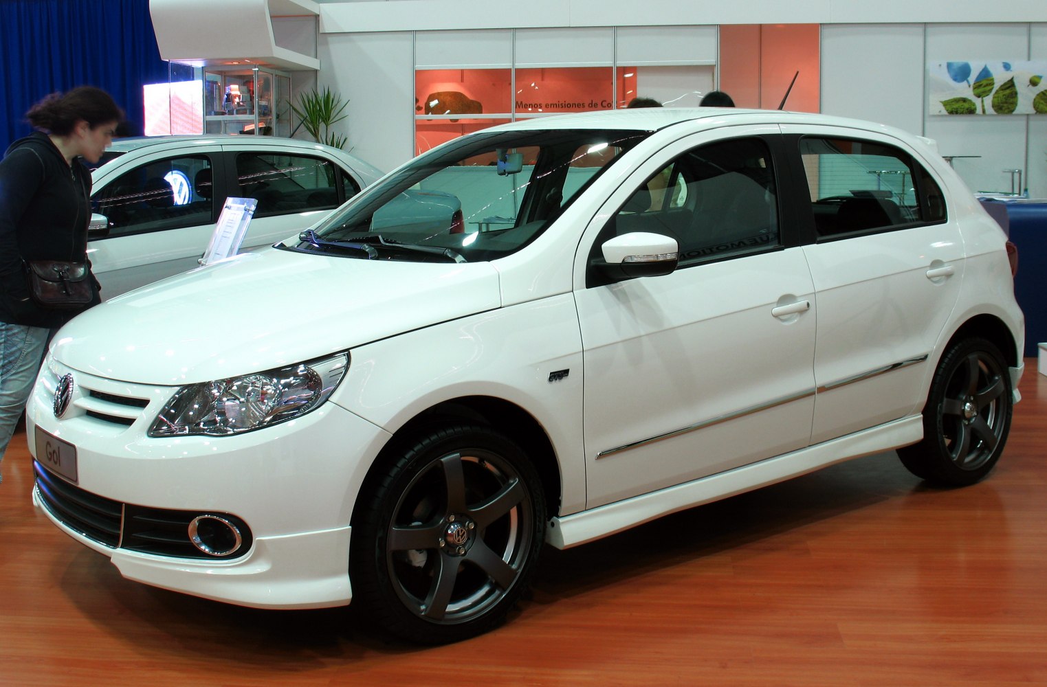 Sporty white hatchback with dark alloy wheels and modern headlights
