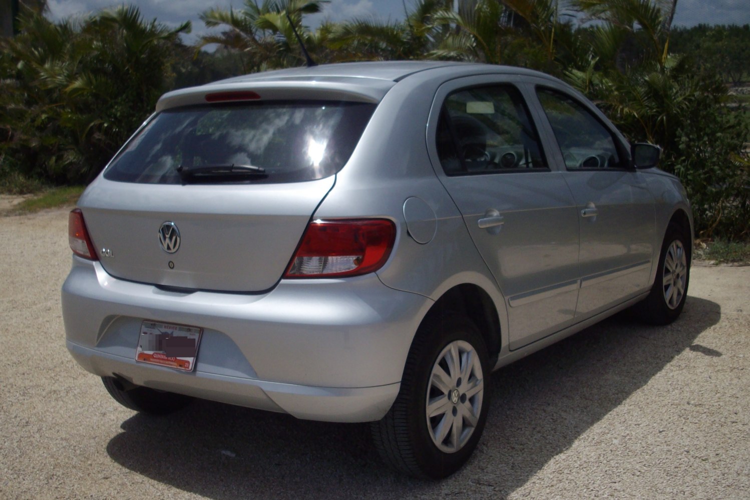 Rear side view of silver hatchback with taillights and rear windshield wiper