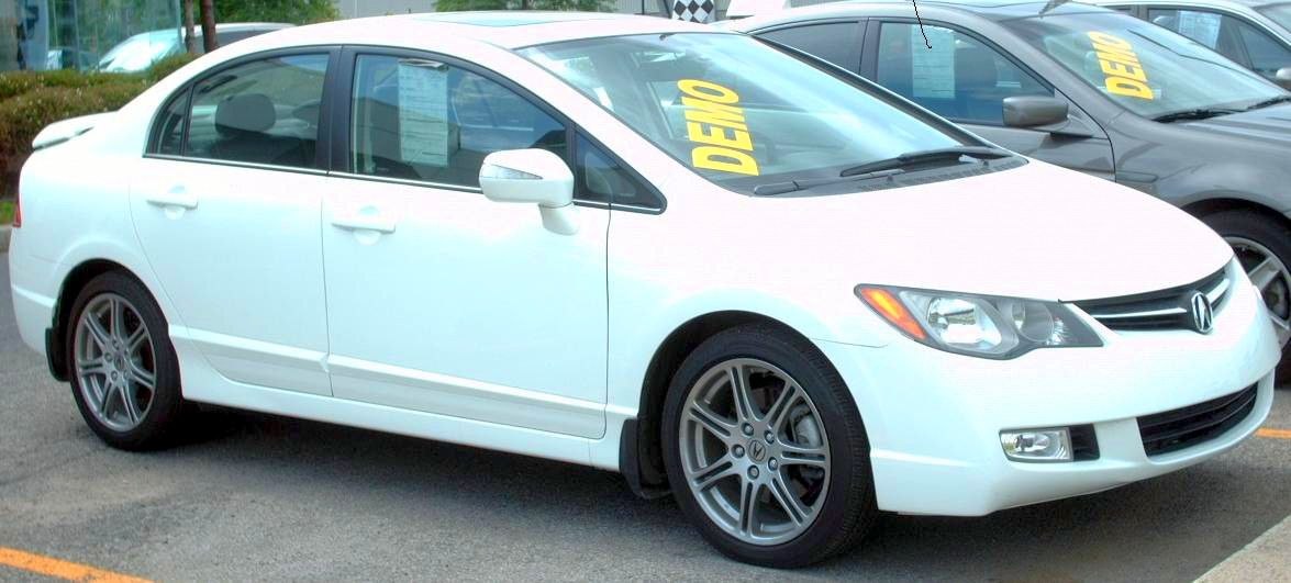 White sedan with alloy wheels and clear front side view
