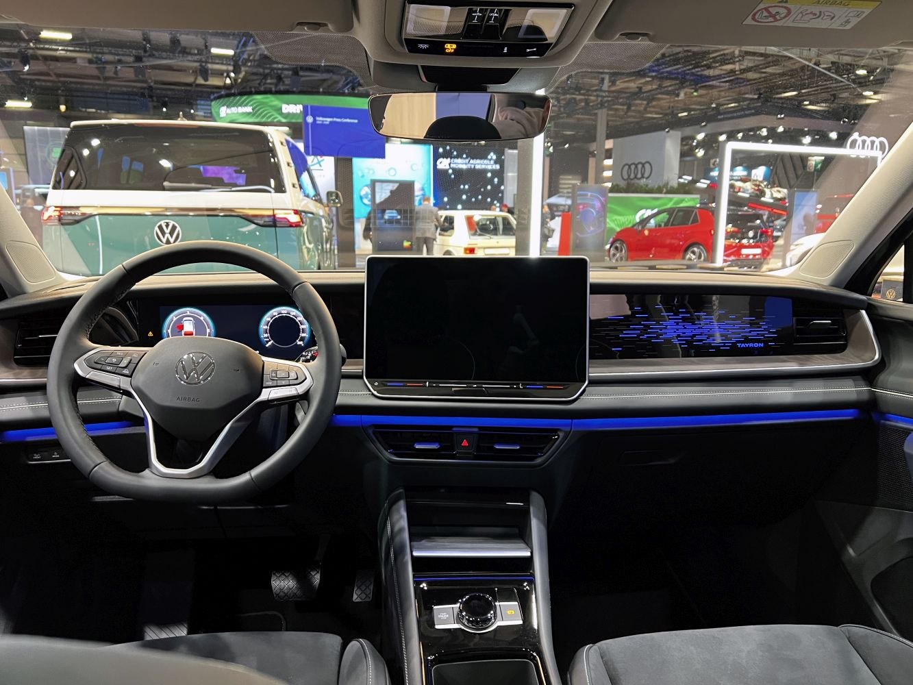 Digital dashboard and central touchscreen display with steering wheel and ambient lighting
