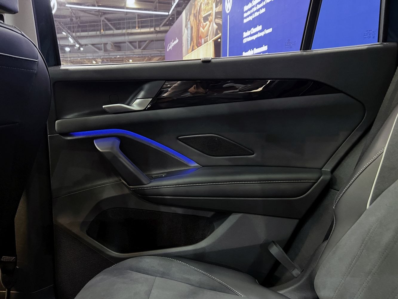 Rear door interior with ambient blue lighting and premium materials