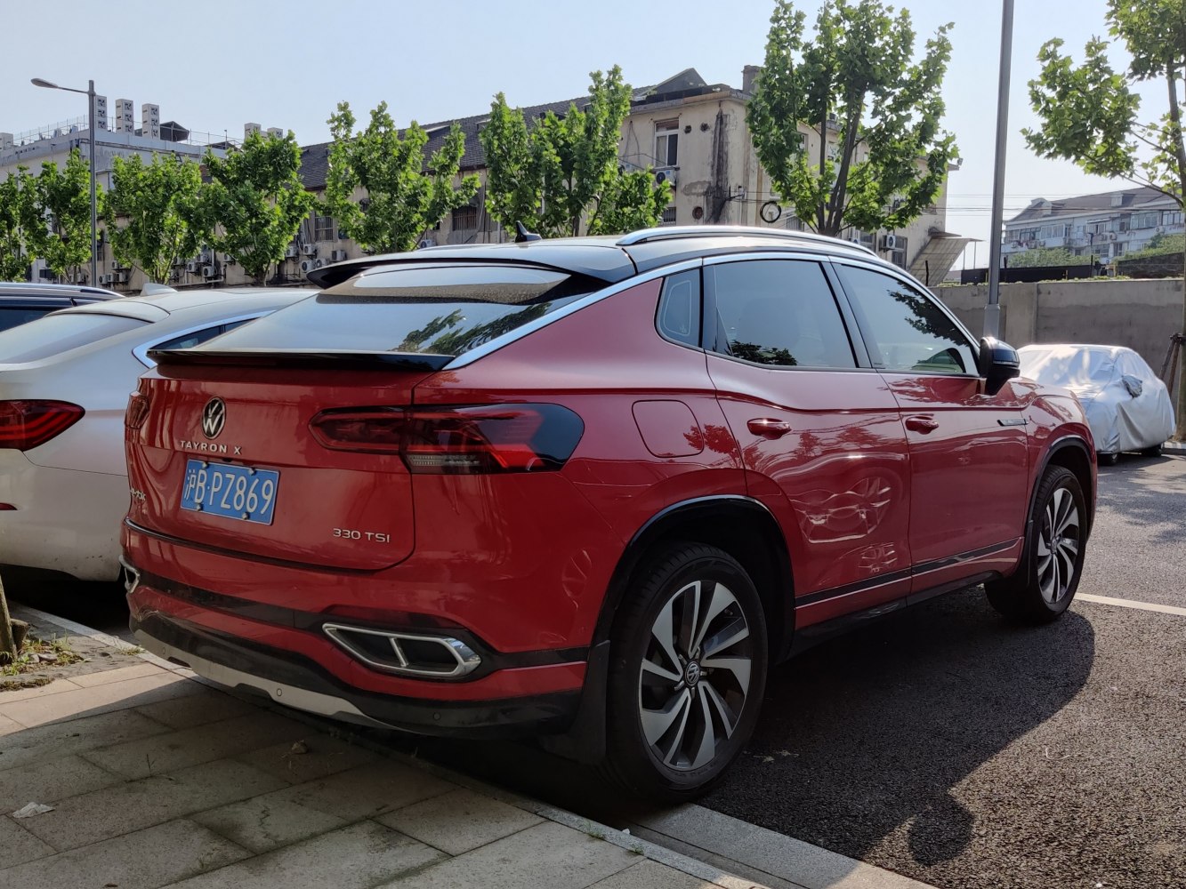 Rear side view of red SUV with 330 TSI badge and sleek tail lights