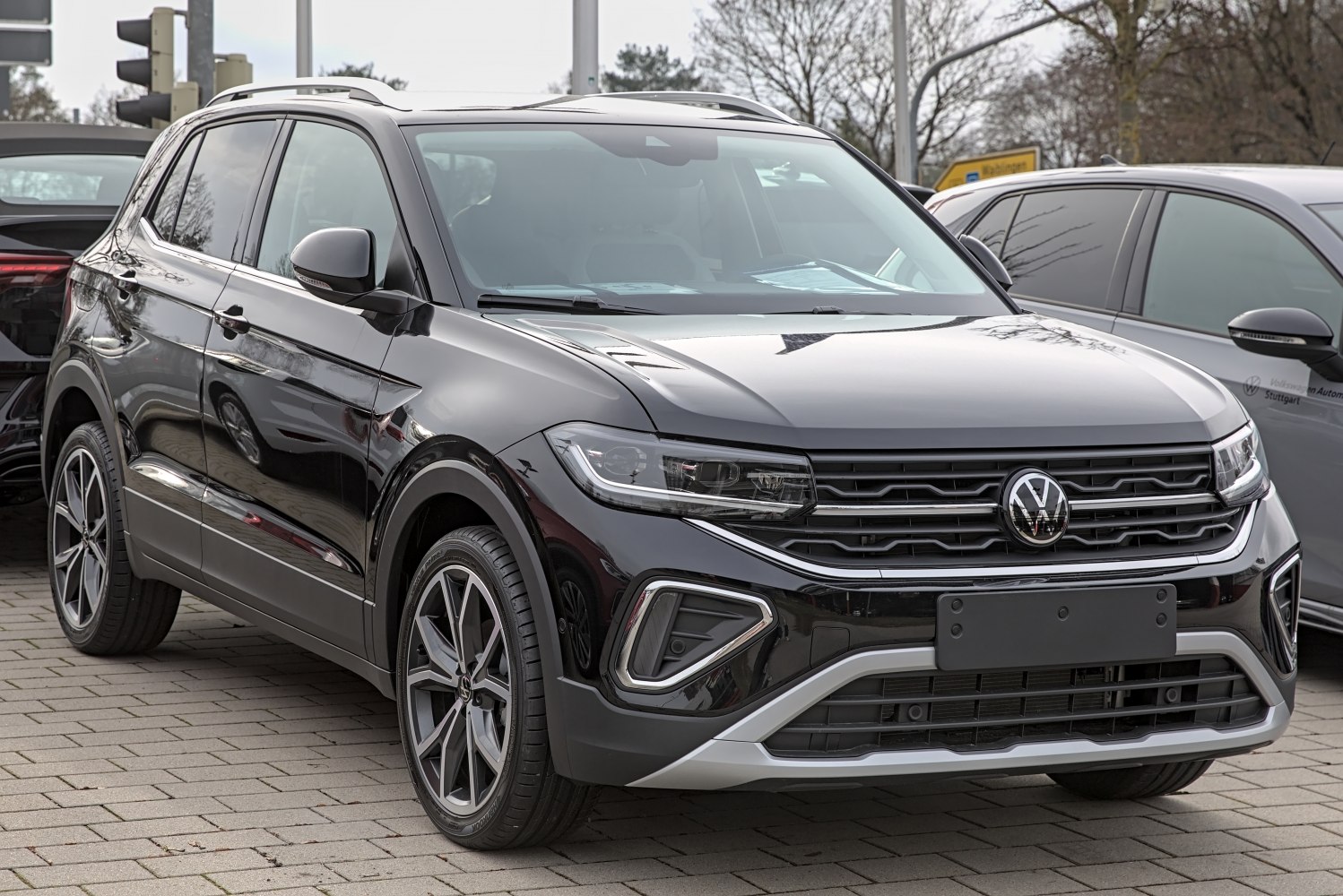 Front view of a modern compact SUV with LED headlights and bold grille.