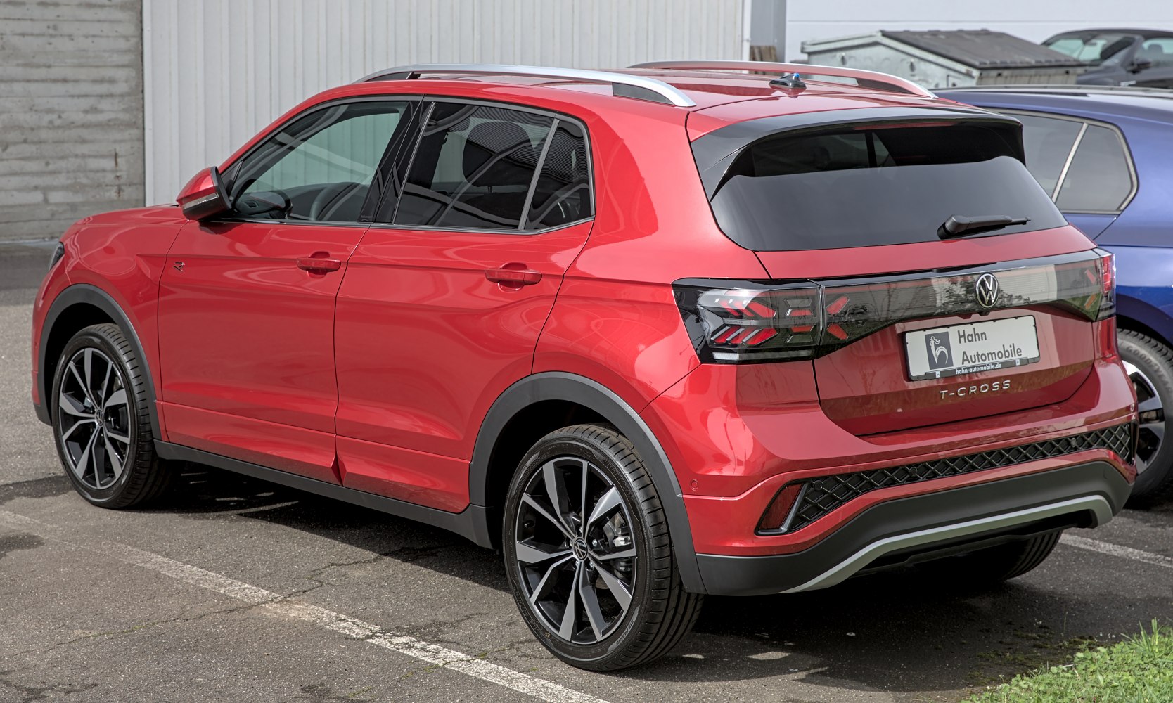 Red compact SUV rear three-quarter view with updated taillights and alloy wheels