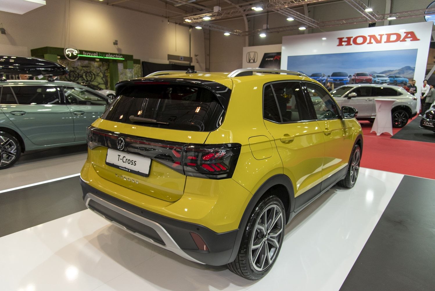 Rear and side view of a yellow SUV with modern taillights and alloy wheels.