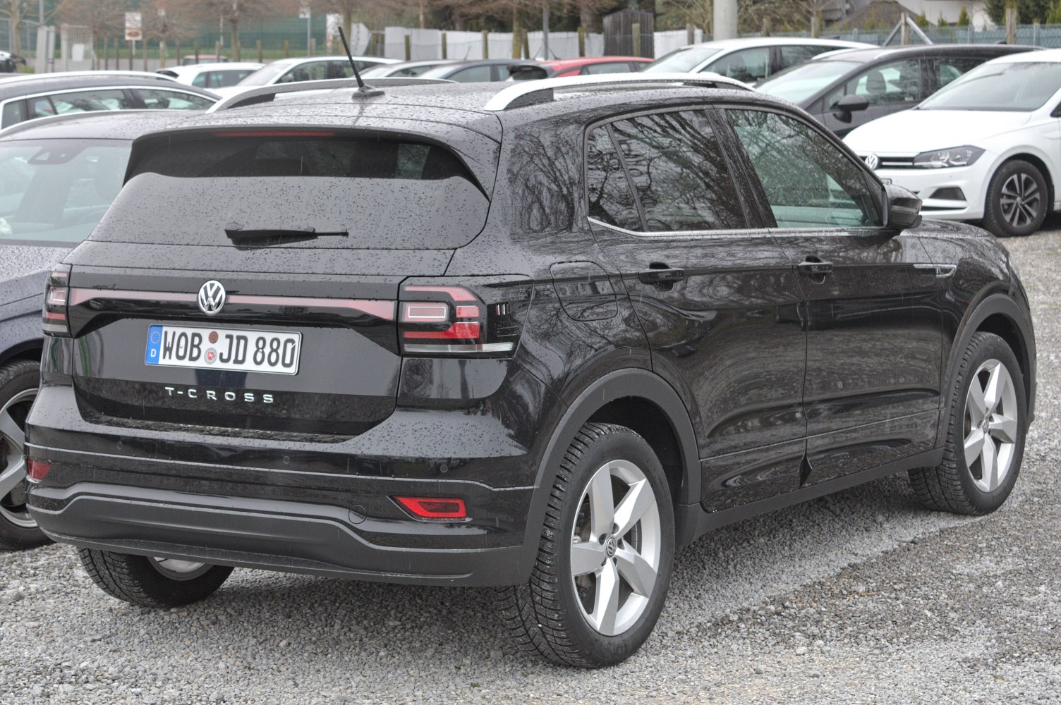 Rear and side view of black compact SUV with distinct tail lights and roof rails.