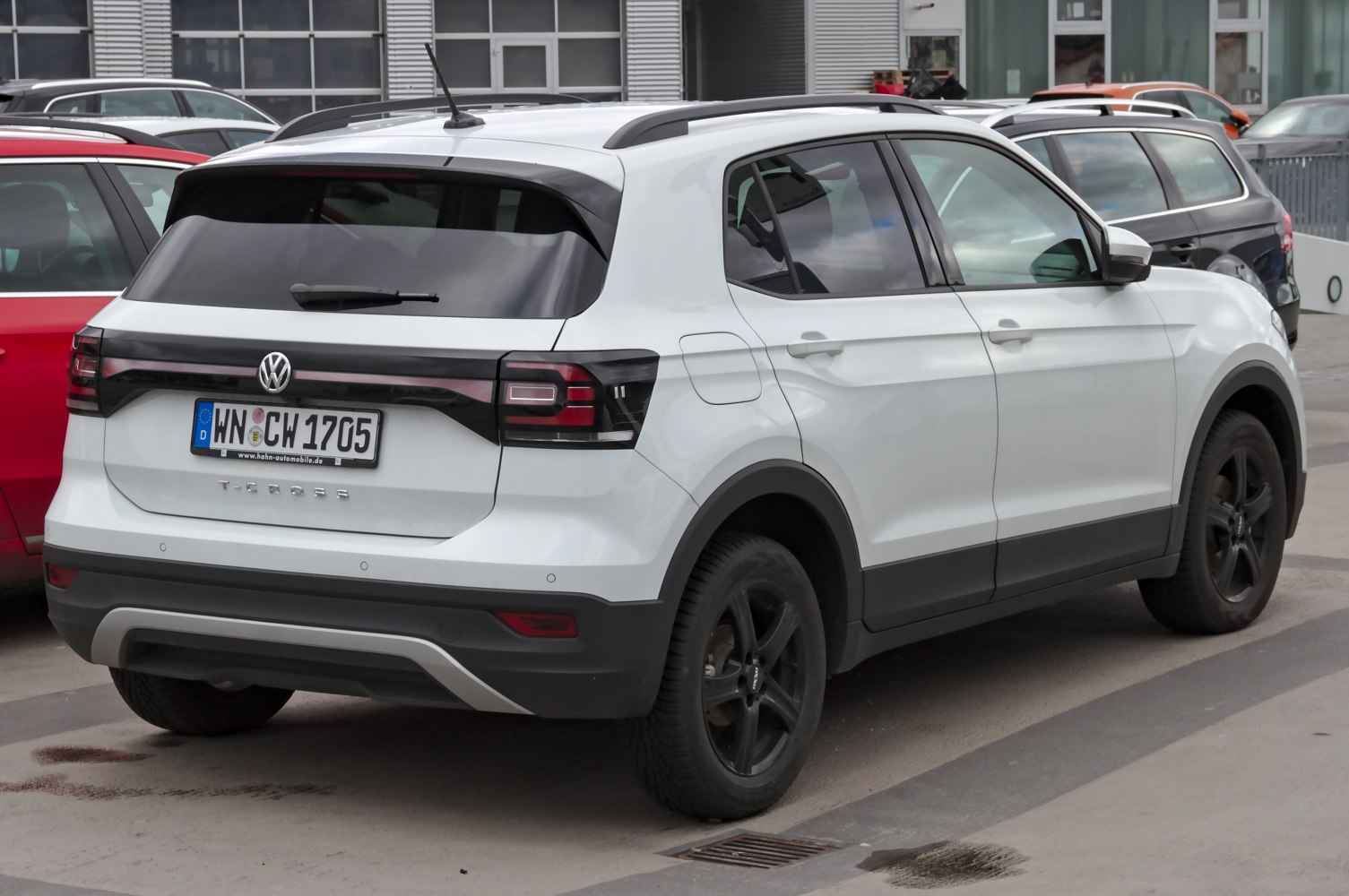 Rear view of compact SUV with black-trimmed taillights and roof rails