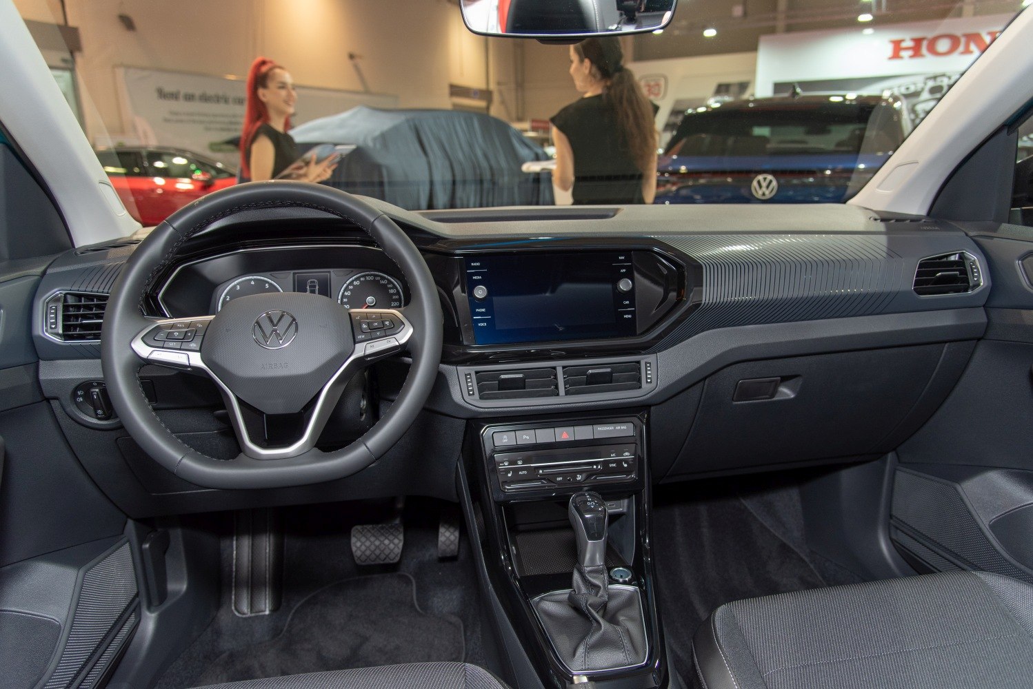 Modern car interior with multifunction steering wheel and touchscreen dashboard